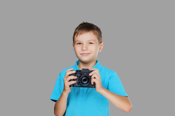istock A boy taking pictures with a professional camera. 1075067838