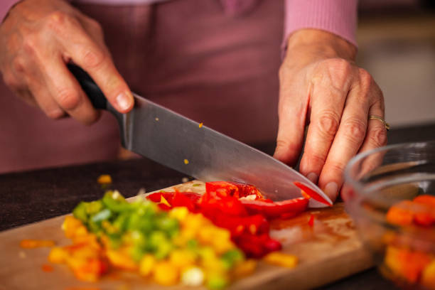 istock Woman chopping vegetables 1075068412