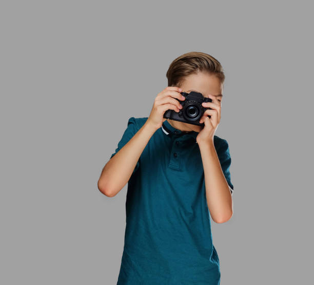 istock A boy taking pictures with a professional camera. 1075068924
