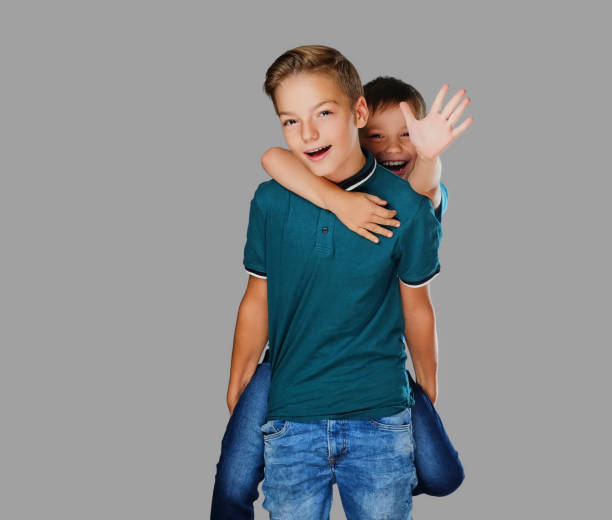 Two teenage boys. Piggy back rides.