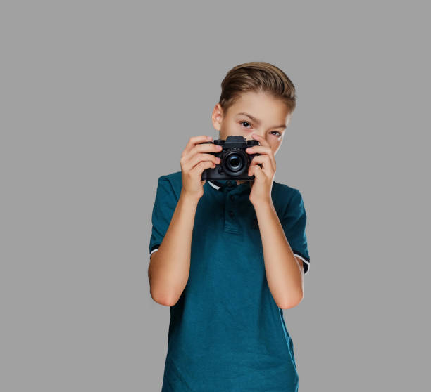 istock A boy taking pictures with a professional camera. 1075069458