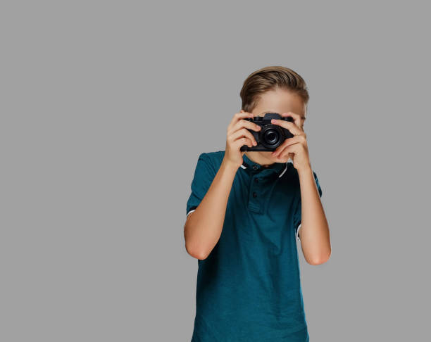 istock A boy taking pictures with a professional camera. 1075070648