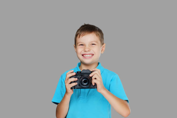 istock A boy taking pictures with a professional camera. 1075070830