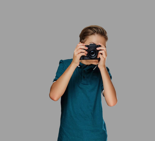 istock A boy taking pictures with a professional camera. 1075072260