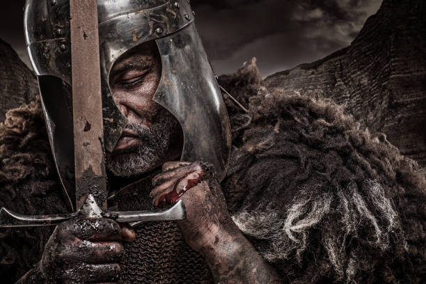Quilpue, Chile - October 11, 2025: Close-up photograph of a man wearing a helmet and all the other accessories for a medieval sword fighting demonstration at a medieval fair in Quilpue on a sunny day.