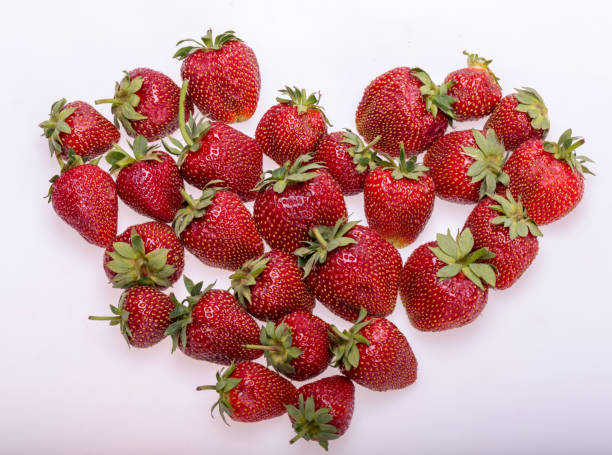 istock fresh ripe strawberries isolated on white background 1075083326