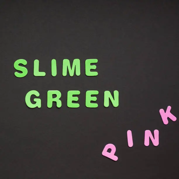 Photo of Slime green writing on black paper background