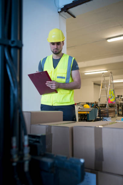 istock Warehouse worker reviewing a new shipment of material 1075086332