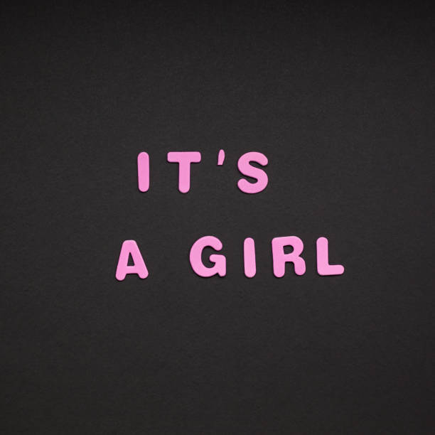 istock It's a girl writing on black paper background 1075086664
