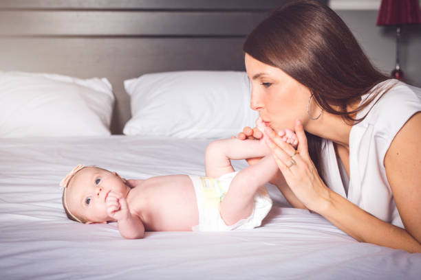istock A happy mother with baby on bed 1075087432