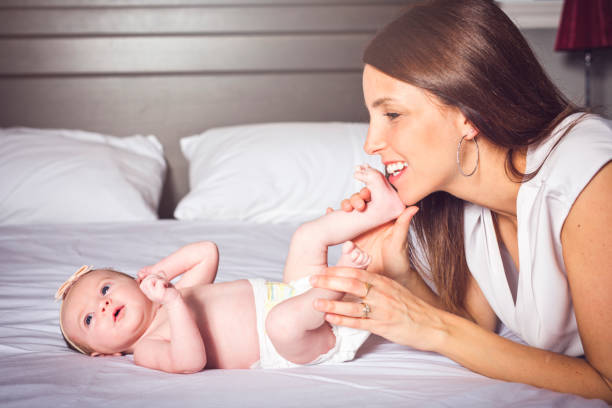istock A happy mother with baby on bed 1075087438