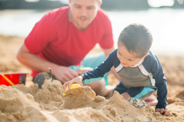 istock Father and son playing at the beach 1075089250