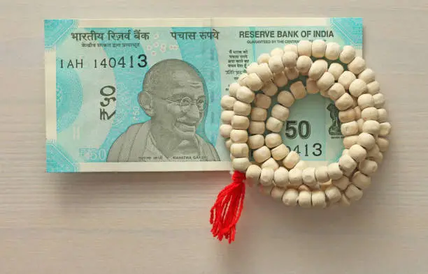 A new banknote of India with a denomination of 50 rupees. Indian currency. Mahatma Gandhi and rosary, beads of Tulasi tree.