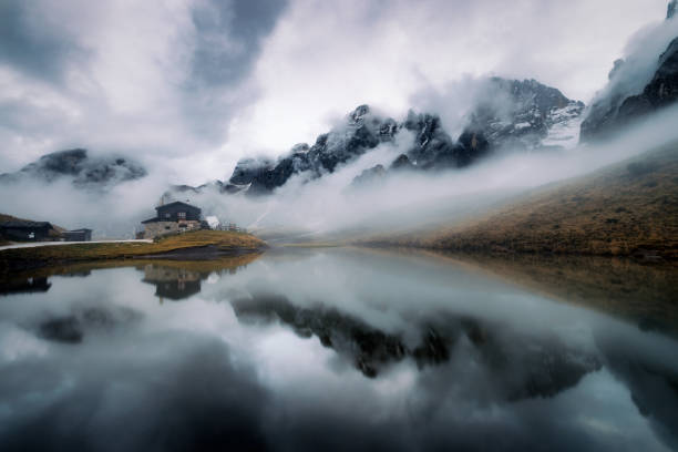 rifugio mountain peak reflection in the moist in Dolomite stock photo