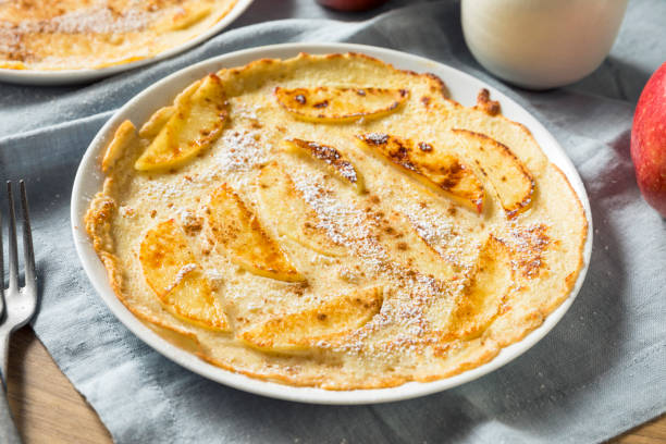 Homemade Apple Dutch Pannekoek Pancake Homemade Apple Dutch Pannekoek Pancake with Powdered Sugar apple cinnamon pancake stock pictures, royalty-free photos & images