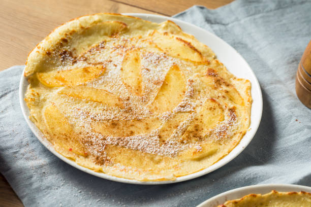 Homemade Apple Dutch Pannekoek Pancake Homemade Apple Dutch Pannekoek Pancake with Powdered Sugar apple cinnamon pancake stock pictures, royalty-free photos & images