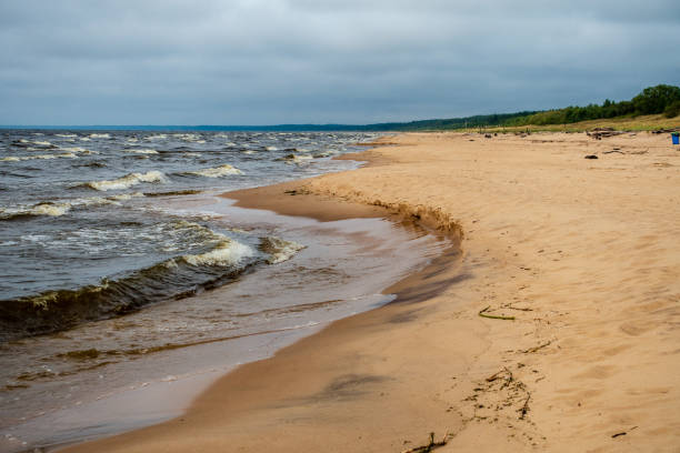istock storm clouds forming over clear sea beach with rocks and clear sand 1075093744