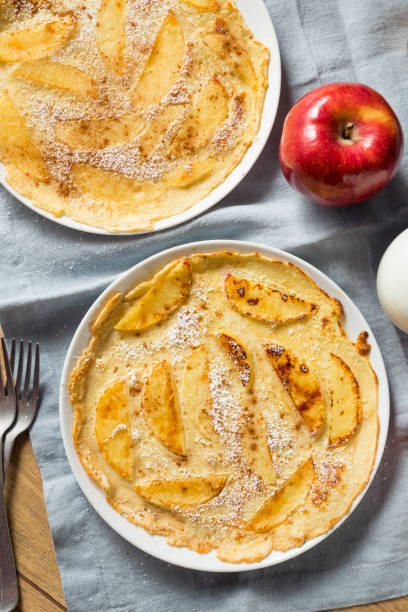 Homemade Apple Dutch Pannekoek Pancake Homemade Apple Dutch Pannekoek Pancake with Powdered Sugar apple cinnamon pancake stock pictures, royalty-free photos & images