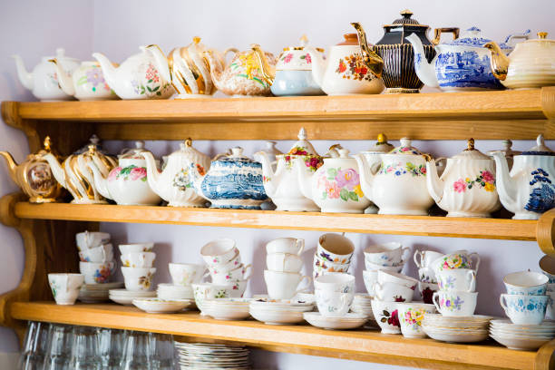 shelves with porcelain and ceramics dishes stock photo