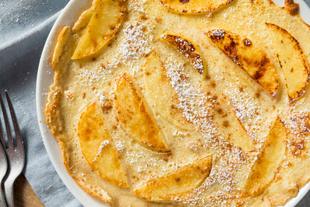 Homemade Apple Dutch Pannekoek Pancake Homemade Apple Dutch Pannekoek Pancake with Powdered Sugar apple cinnamon pancake stock pictures, royalty-free photos & images