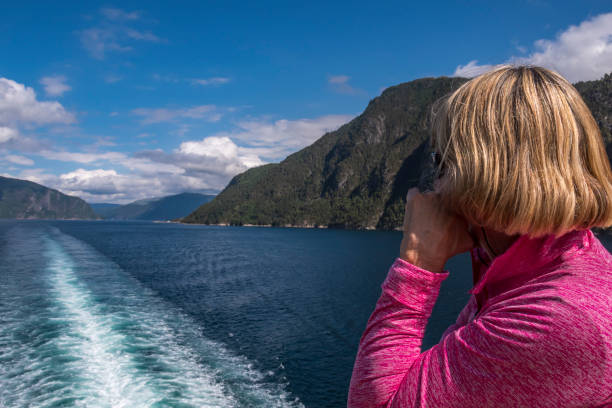 istock Woman Enjoying Coastal Norwegian Scenery from a Cruise Ship 1075100544