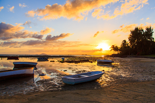 Boats docked during beautiful sunset / sunrise by the coasts of the island