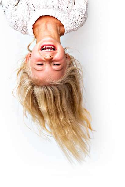 Cute girl 4-5 year old posing in studio upside down Cute girl 4-5 year old posing in studio upside down stock pictures, royalty-free photos & images