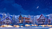 Snowbound alpine mountain town at winter night