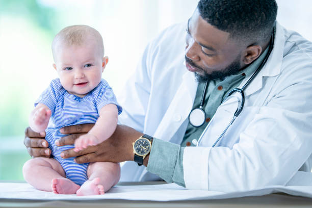 istock Doctor holding baby 1075131368