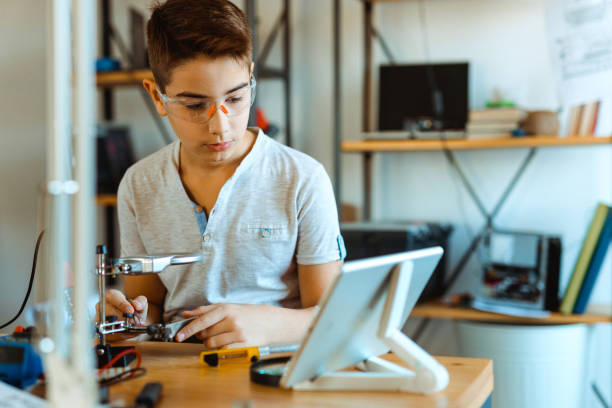 istock Boy electrician repairing computer motherboard in laboratory 1075136908