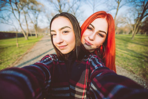 istock Friends making selfies in a park 1075137080