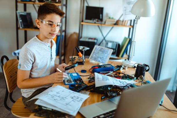 istock Boy electrician repairing computer motherboard 1075139444