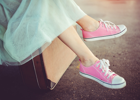 A young modern girl sitting and waiting for a train.