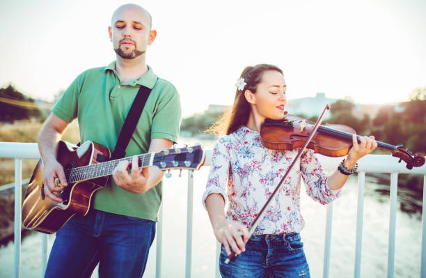 istock Musicians with guitar and violin 1075150130