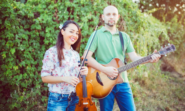 istock Musicians with guitar and violin 1075152912