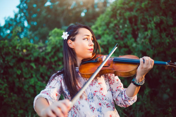 istock Girl violinist in nature 1075156374