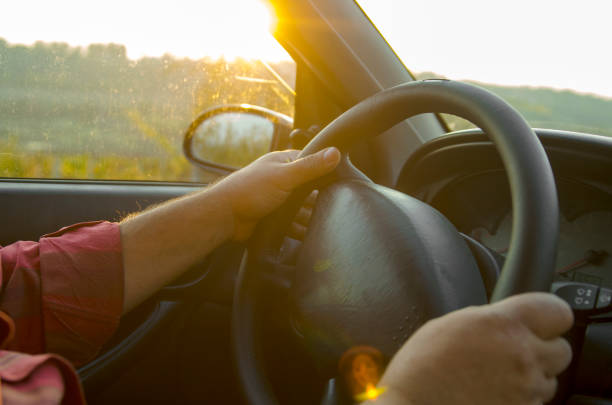 istock Man hands manage the car holding steering wheel. 1075156498