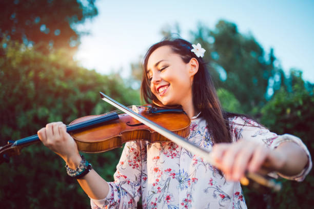 istock Girl violinist in nature 1075156656