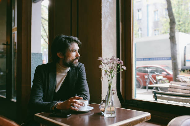 istock Young man relaxing in the cafe, having an espresso in Berlin 1075159748