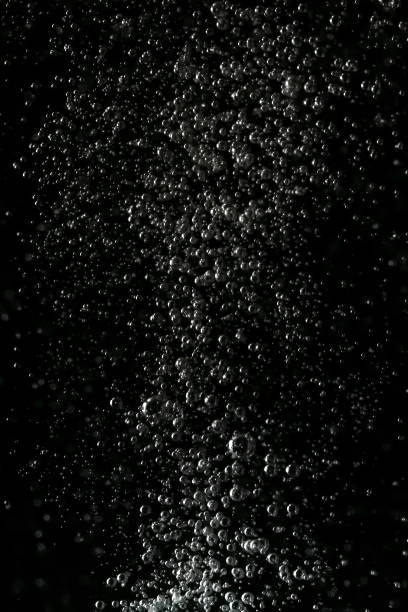 istock Black and white explosion of bubbles moving in water 1075173646