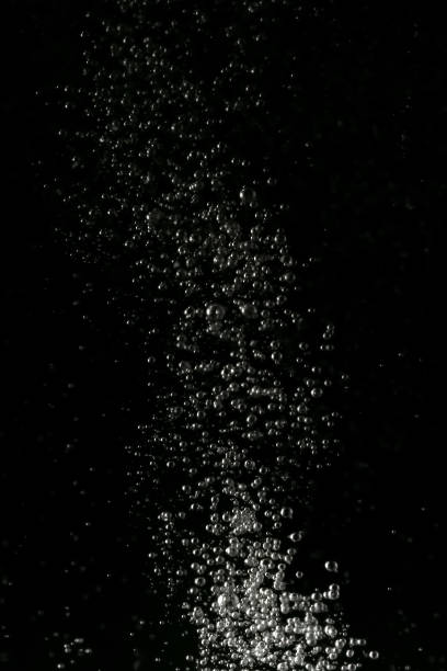 istock Black and white explosion of bubbles moving in water 1075173650