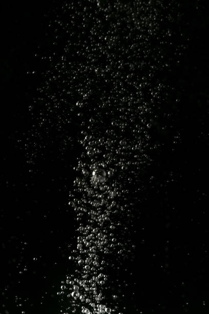 istock Black and white explosion of bubbles moving in water 1075173670