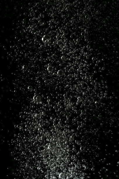 istock Black and white explosion of bubbles moving in water 1075173672
