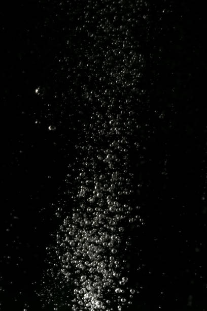 istock Black and white explosion of bubbles moving in water 1075173850