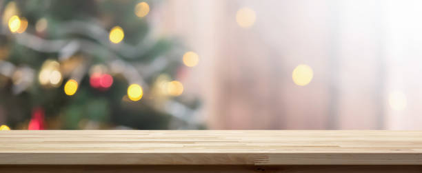 istock Wood table top on colorful bokeh background from decorated Christmas tree 1075181244