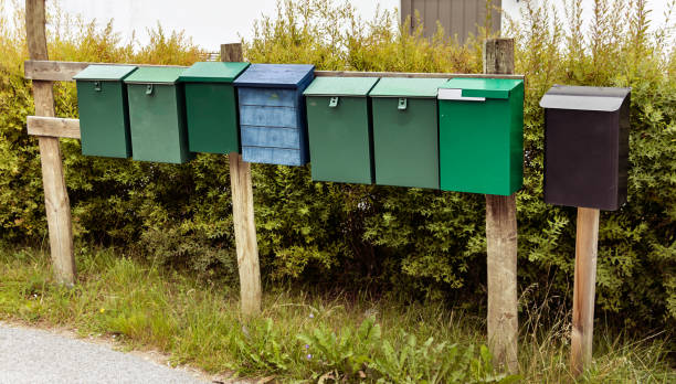 istock Group of mail - post boxes on wooden sticks outdoors in Norway. 1075186788