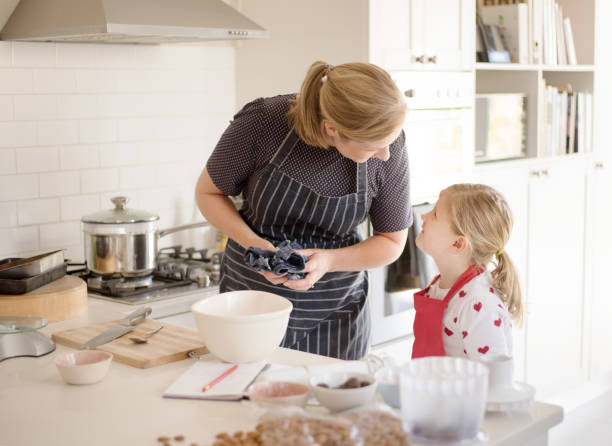 istock Mom and daughter baking in the kitchen 1075199318