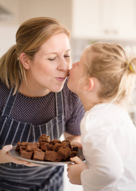 istock Mom and daughter baking in the kitchen 1075199520