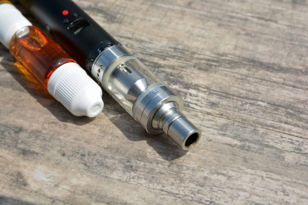 istock E - cigarette for vaping , technical devices.The liquid in the bottle 1075232532