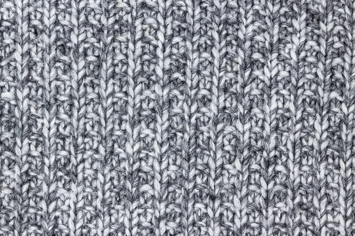 Gray knitted wool texture, Detail of a chunky warm blanket.